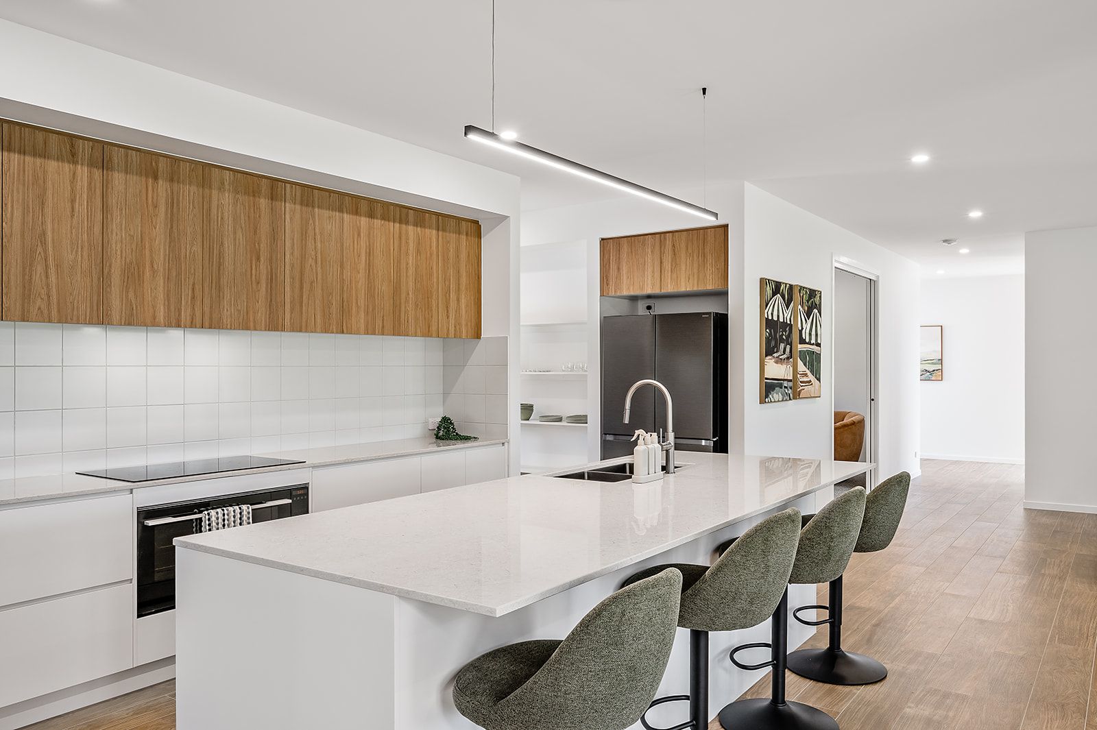White kitchen with timber overheads and a long island