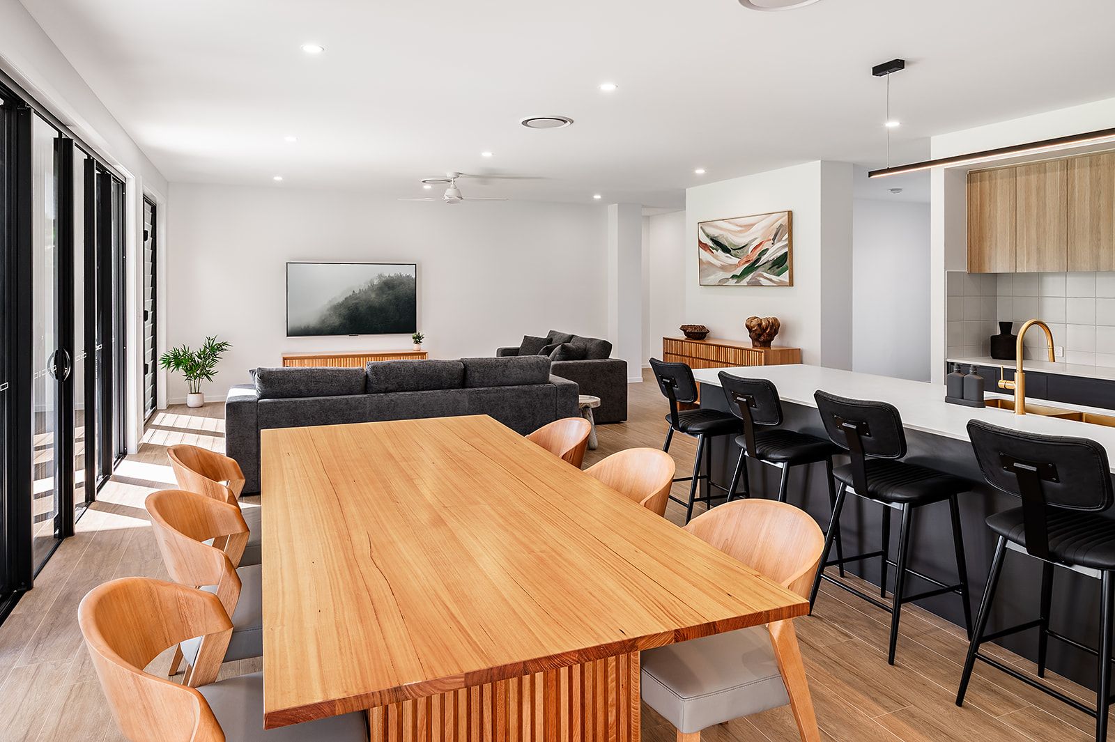 Kitchen and timber dining table opening onto the living room