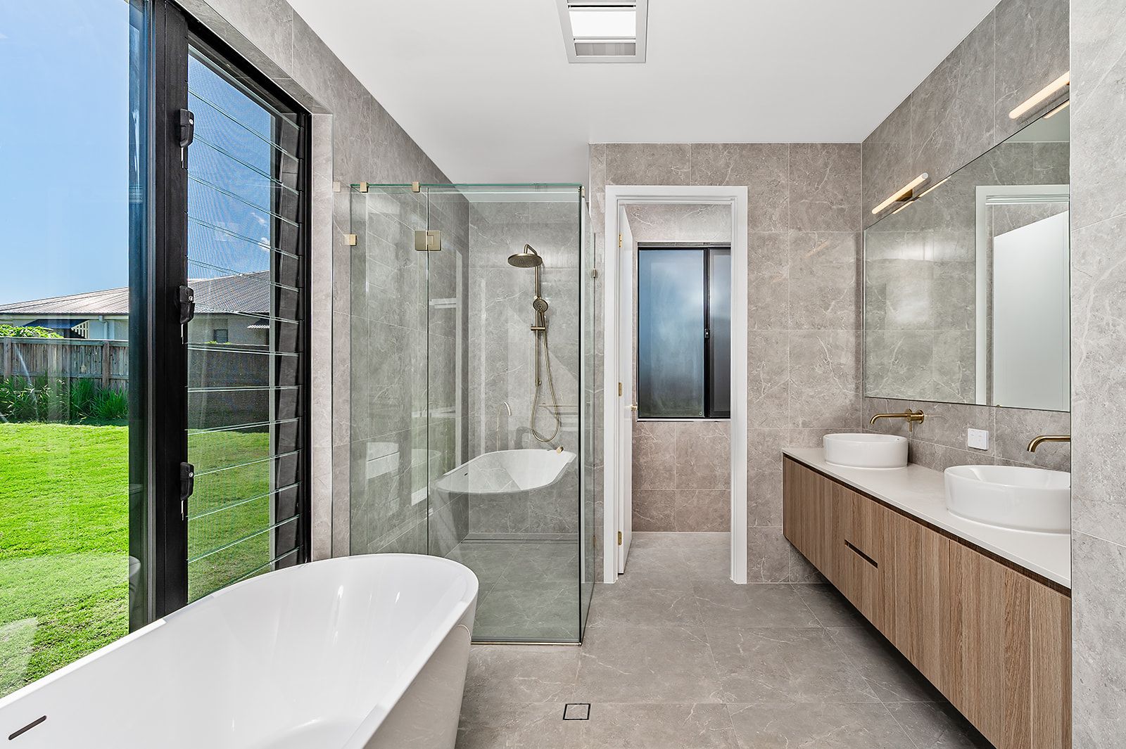 Ensuite with freestanding bath, double vanity and brass tapware