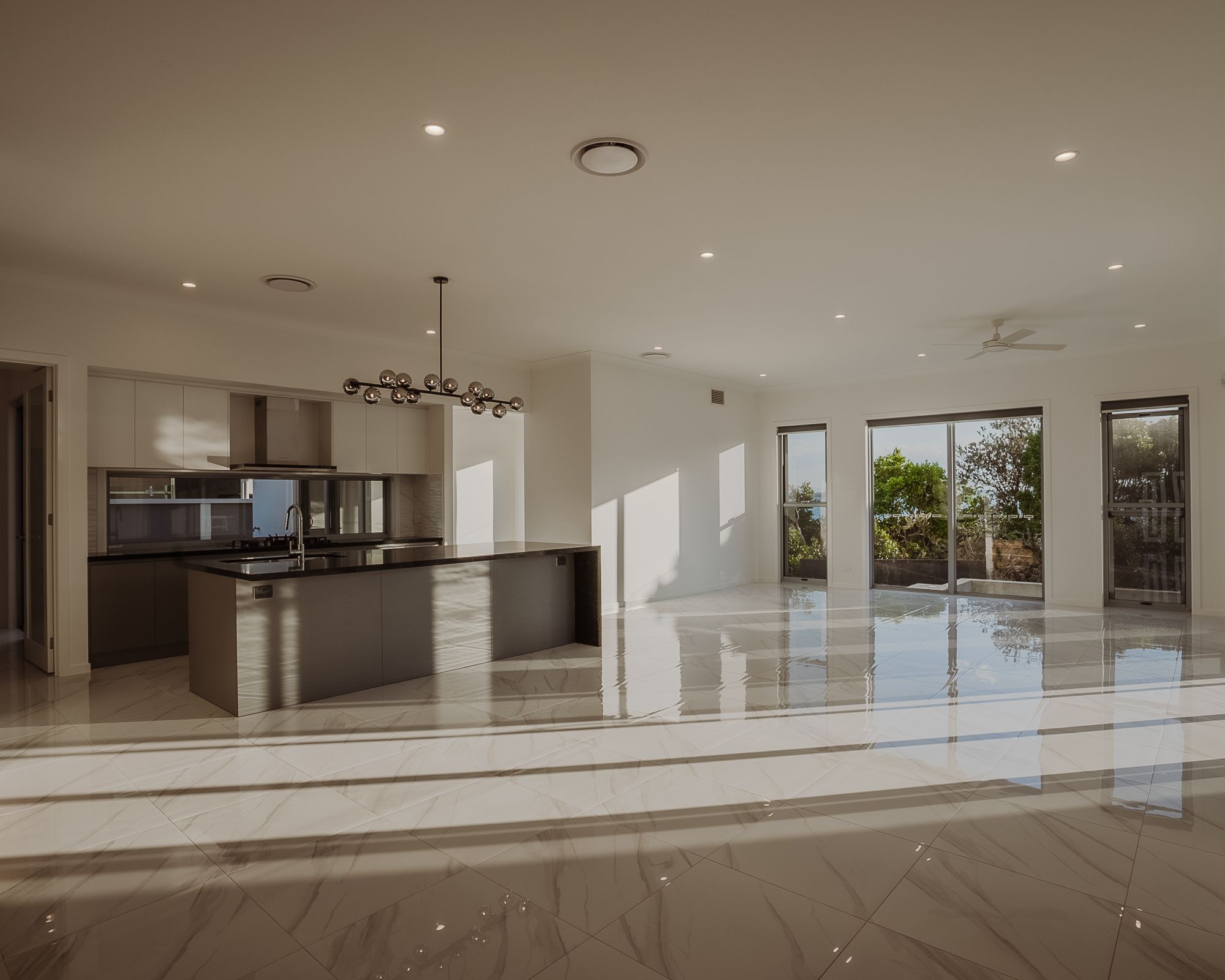 Large open living area with marble floors in a custom home